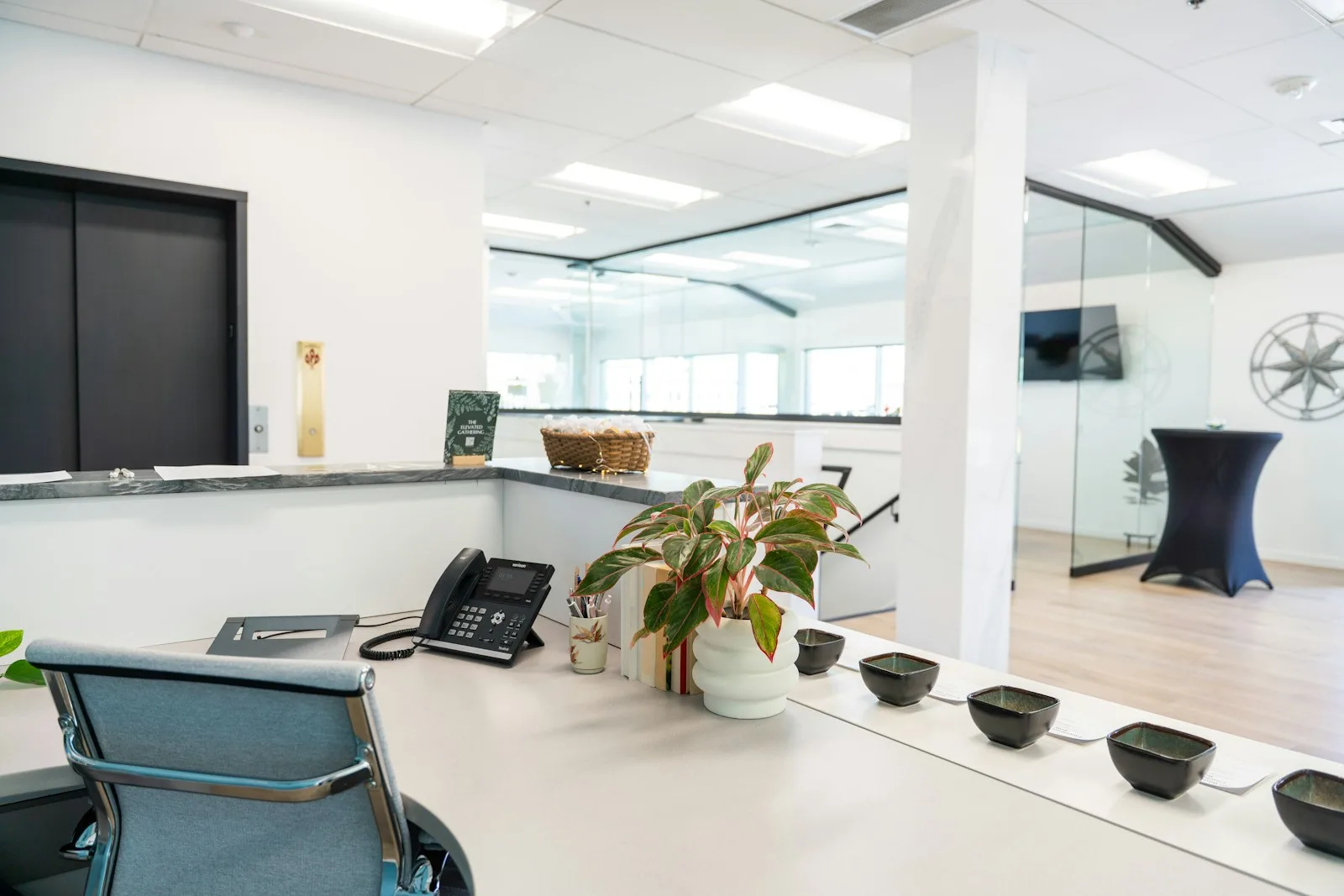 A modern reception desk with an office telephone
