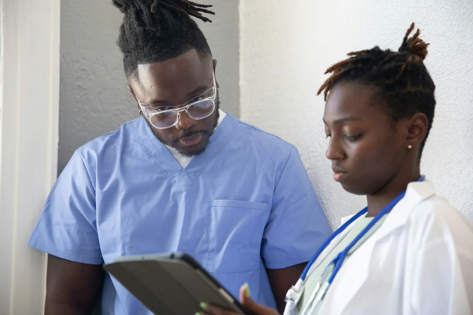 Healthcare professionals reviewing information on a tablet