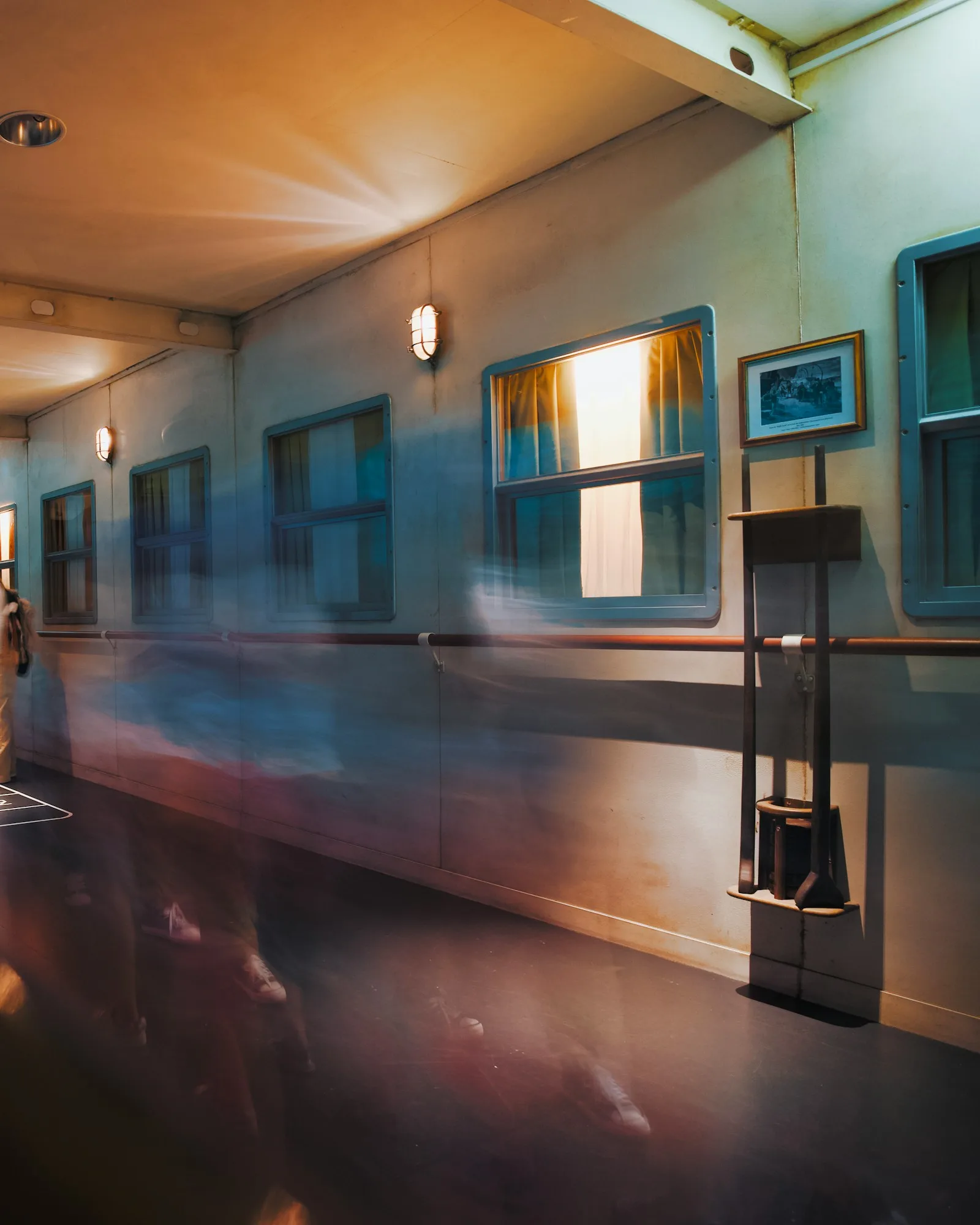 Figures moving through a softly lit hospital corridor