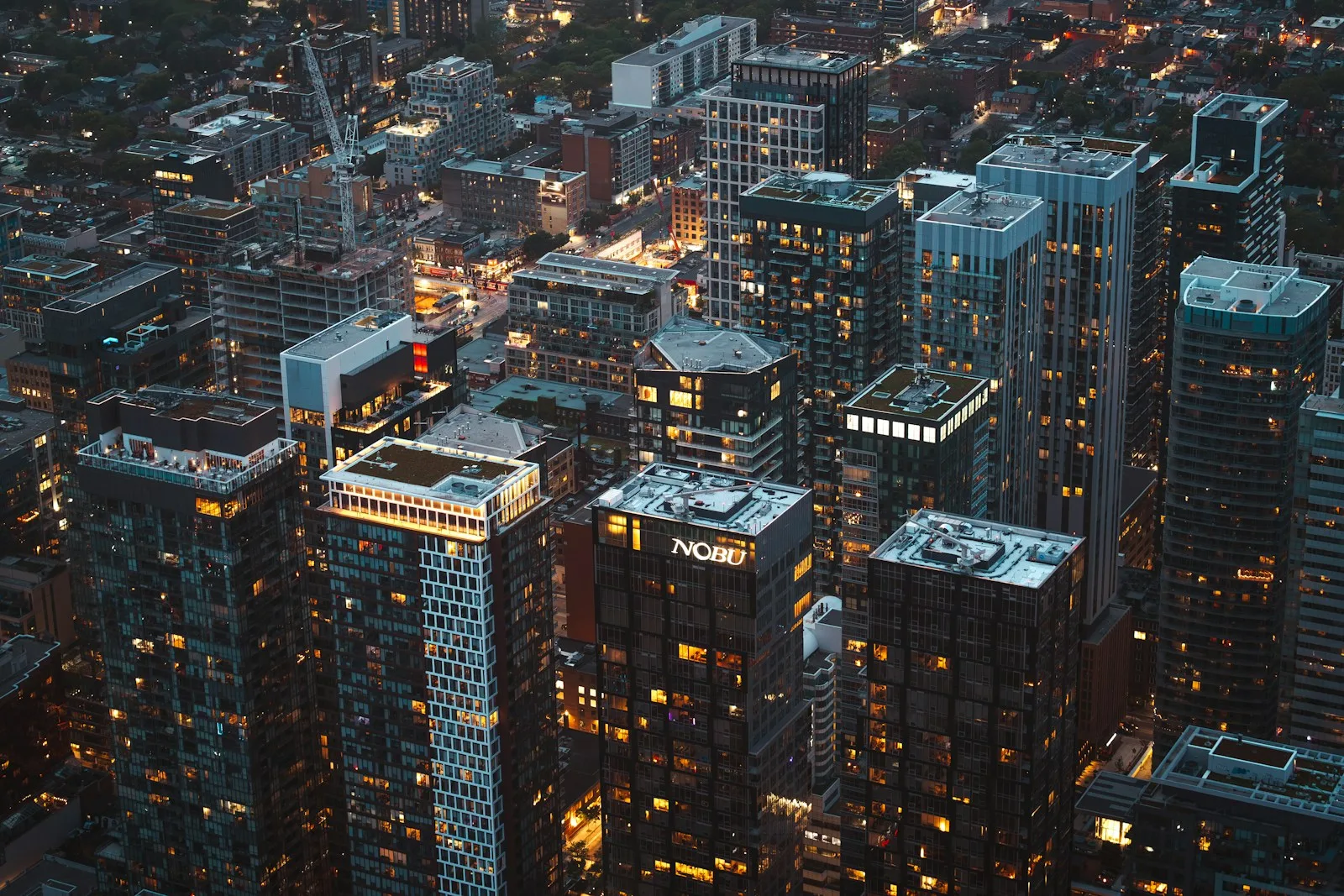 A dense city center viewed from above at dusk