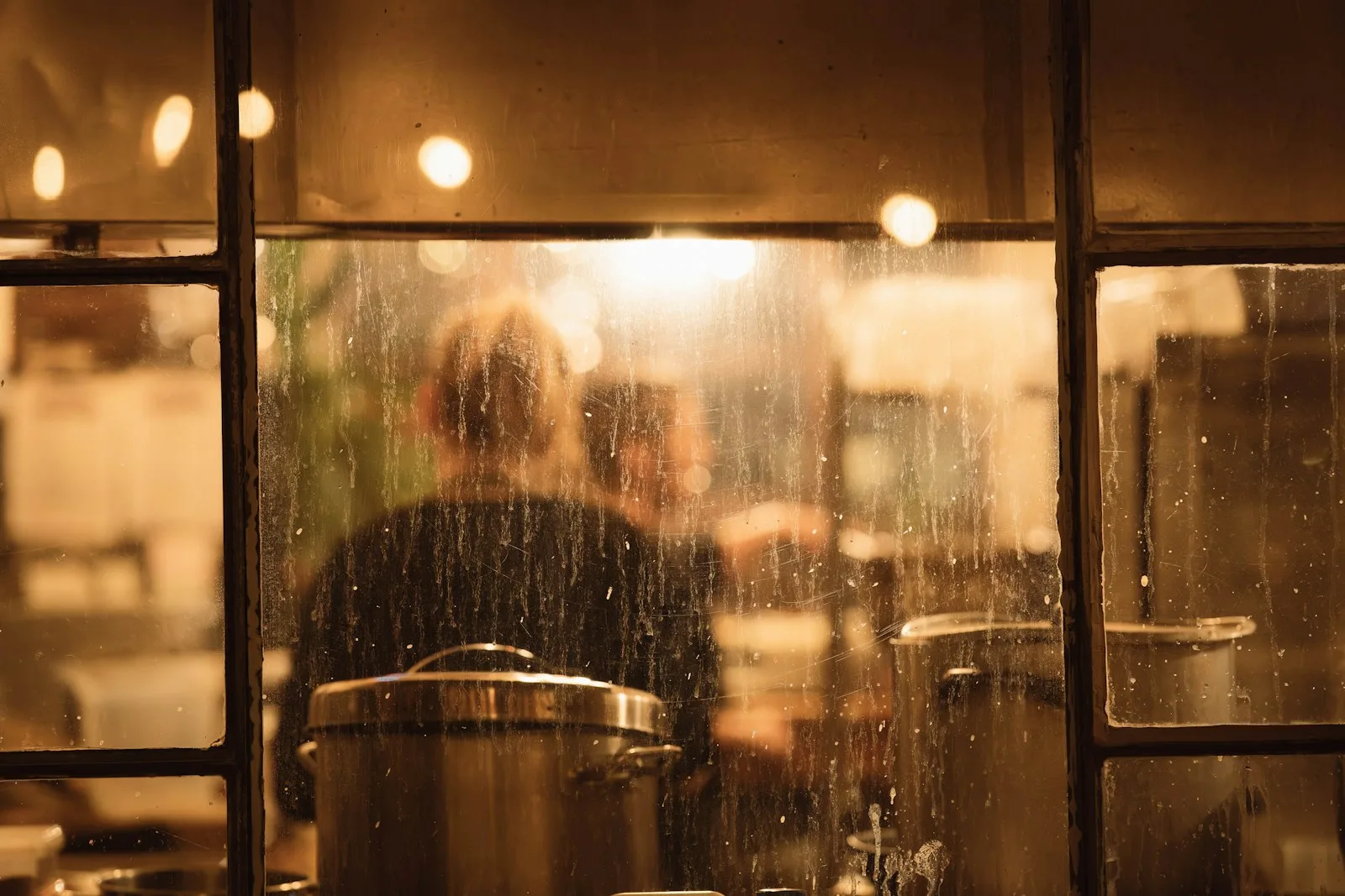 Restaurant staff working behind a kitchen window