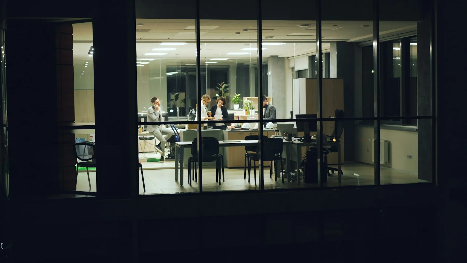 A team collaborating in an office after dark
